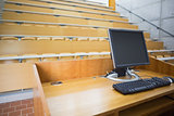 Computer monitor with empty seats in a lecture hall