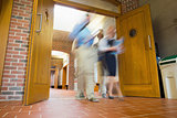Group of blurred people walking through open doors