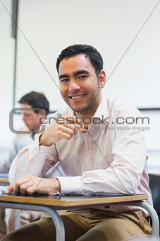 Mature students taking notes in classroom