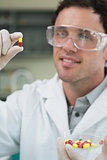 Male scientist analyzing pills in the laboratory