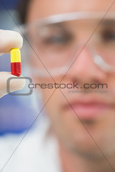 Extreme Close up of a scientist analyzing a pill