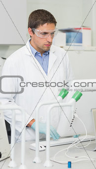 Male researcher using computer in lab
