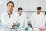 Smiling scientist with colleagues at work in the lab