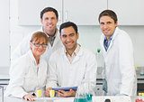 Smiling scientists with tablet PC in the lab