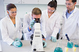 Scientists with microscope in the laboratory