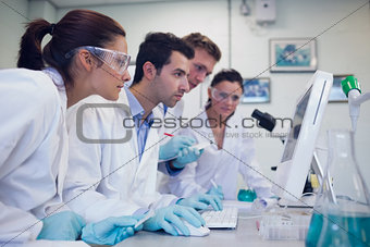 Serious researchers looking at computer screen in the lab