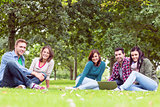 Young college students using laptop in the park