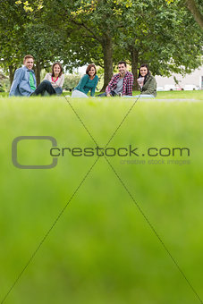 College students sitting on grass in park