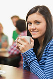 Portrait of a smiling female having coffee at  coffee shop