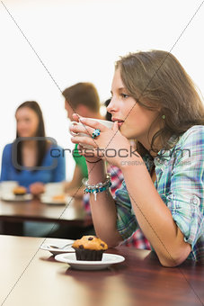 Female having coffee and muffin at  coffee shop