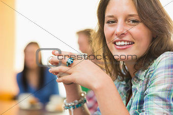 Portrait of a smiling female having coffee at coffee shop