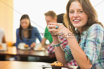 Female having coffee and muffin at  coffee shop