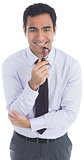 Smiling businessman holding glasses