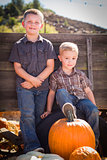 Two Boys at the Pumpkin Patch Against Antique Wood Wagon