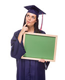 Thinking Female Graduate in Cap and Gown Holding Blank Chalkboar