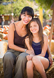 Attractive Mother and Daughter Portrait at the Pumpkin Patch 
