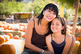 Attractive Mother and Daughter Portrait at the Pumpkin Patch 