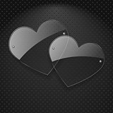 Vector two glass hearts over metal background