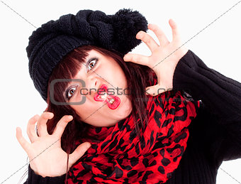 Young Woman in Cap Posing Hands as Claws  