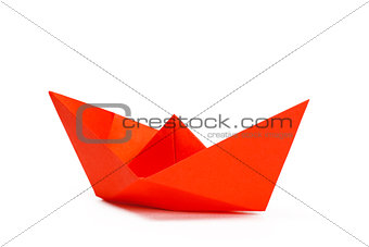 Red paper ship on a white background