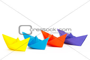 Four colored paper ship on a white background