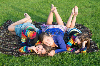 Girls have a rest on a grass.