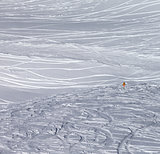 Traces of skis and snowboards in new fallen snow and warning sig
