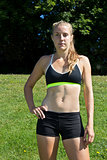 Athletic woman in a sports bra and shorts