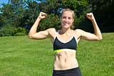 Fit, athletic woman flexing her muscles