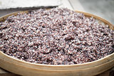 Steam black rice in big wooden plate