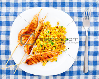 Honey chicken skewers with grilled corn salad