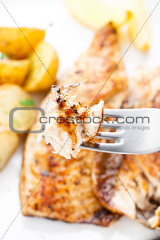 Fried mackerel on a fork