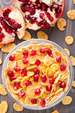 Sugar coated corn flakes with milk and pomegranate
