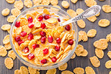 Sugar coated corn flakes with milk and pomegranate