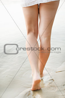 Woman walking on sand beach