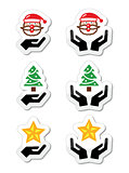 Hands with christmas icons - santa claus, tree, star