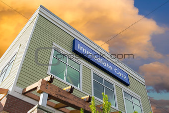 Immediate Care Sign On Hospital Building with Clouds