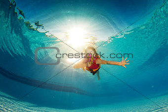 little girl underwater with flowers