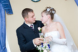 bride and groom with glasses of champagne