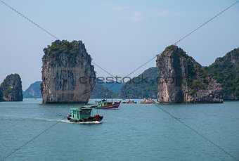 Rocky islands and boats in Halong Bay