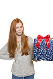 Young red haired Girl presenting a gift