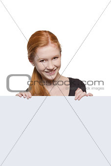 Teen girl holding a sign with copyspace for adverts