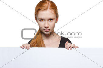 Teen girl holding a sign with copyspace for adverts