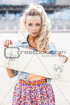 beautiful young lady with a skateboard with blank deck