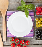 Empty plate on wooden with fruits and utensils