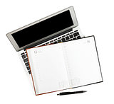 Blank notepad over laptop