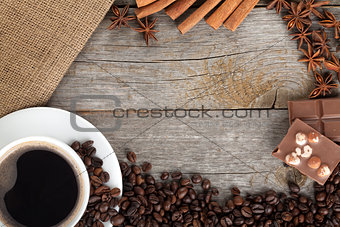 Coffee cup and spices on wooden table texture