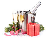 Christmas champagne bottle in bucket, glasses and gift box