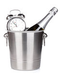 Champagne bottle in bucket and alarm clock