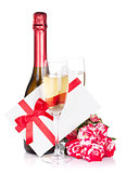 Champagne bottle, two glasses, letter and red rose flowers